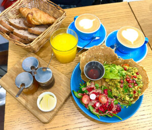 Vegan breakfast at the Parisian Cloud Cakes: tofu scramble with pancakes served with avocado and salad, and a croissant, nut bread with various spreads, fresh juice, and 2 cappuccino